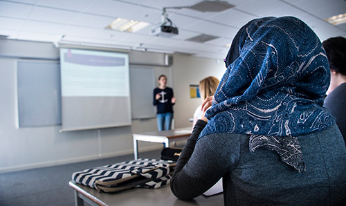 Person sat in a workshop presentation listening to speaker