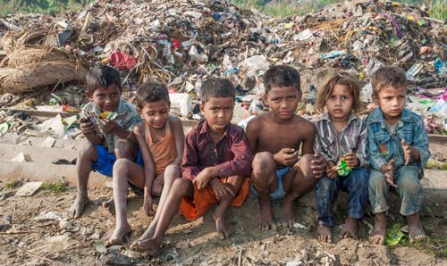 Children sat on floor looking at camera